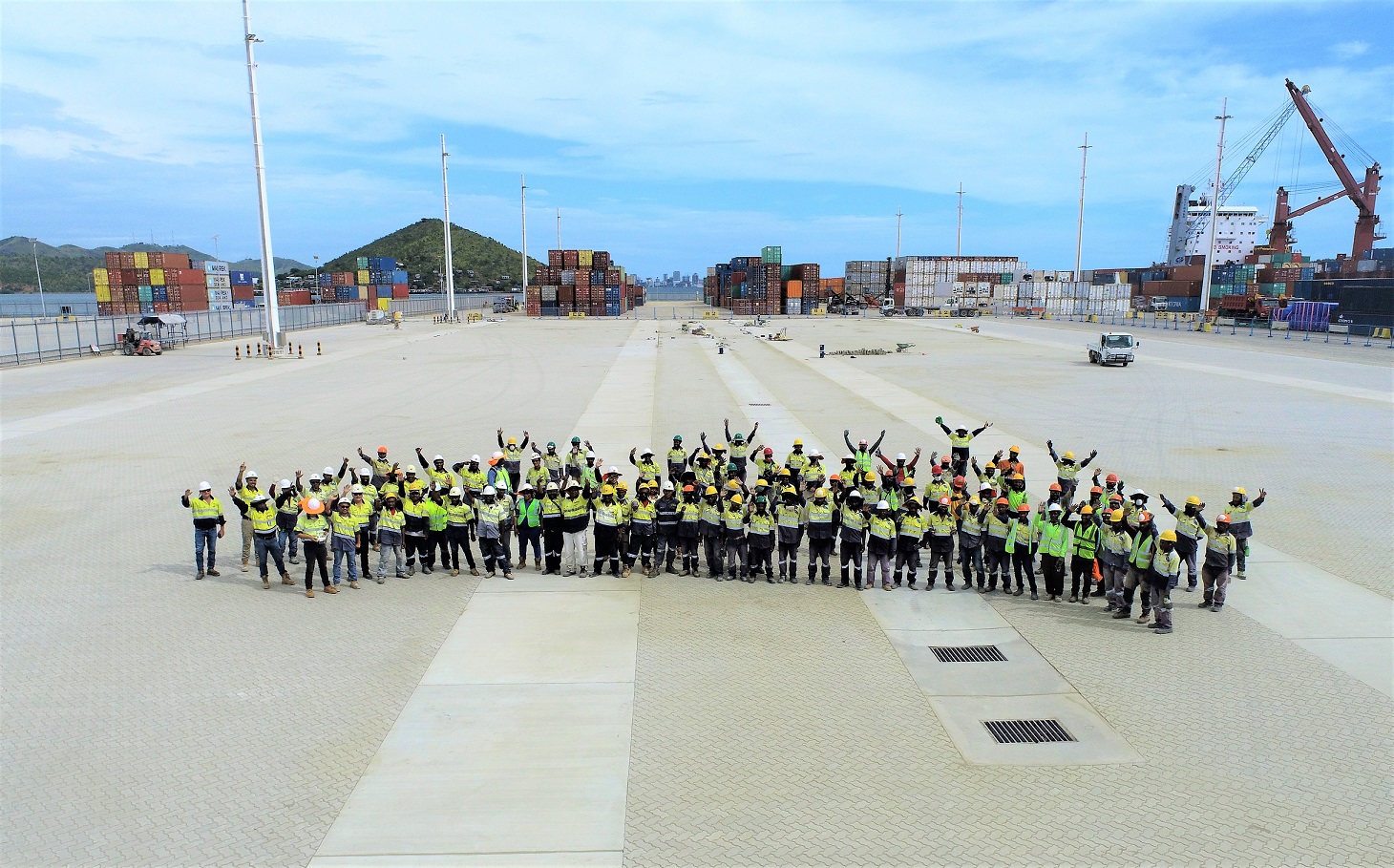 Construction team standing on the paved container yard at Motukea Port.