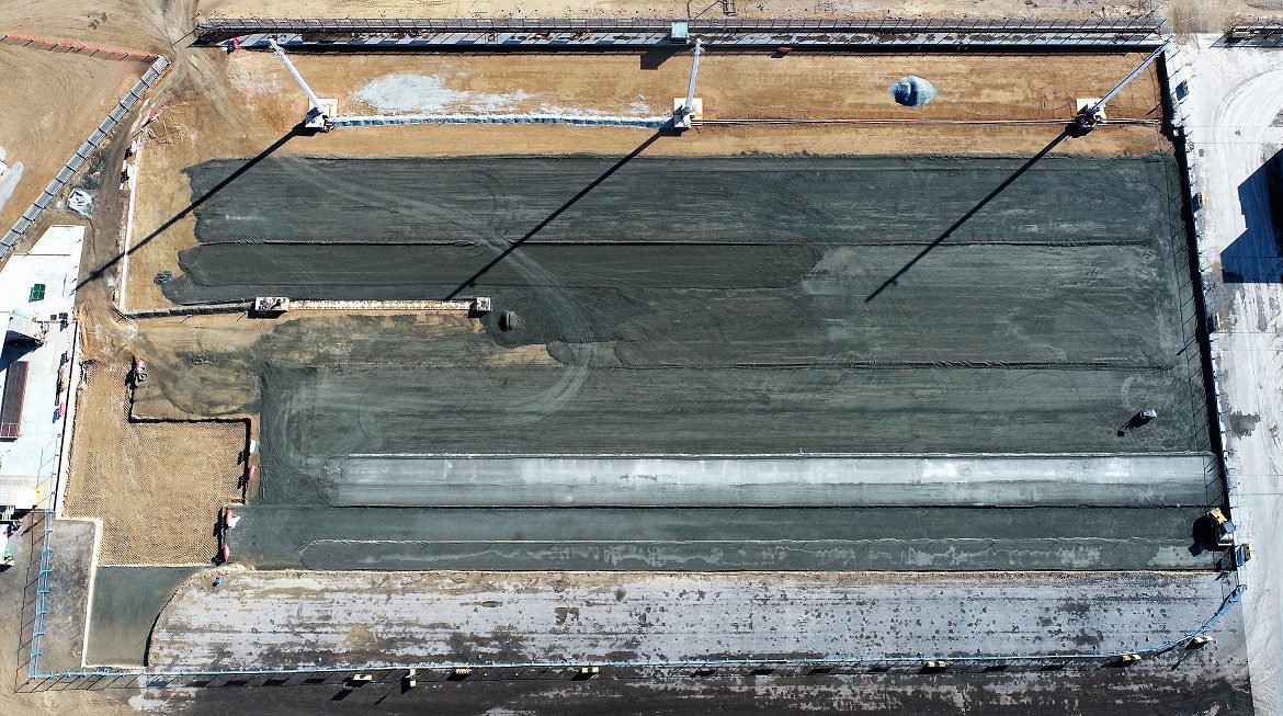 Overhead view of pavement construction within a fenced work area at Motukea Port.