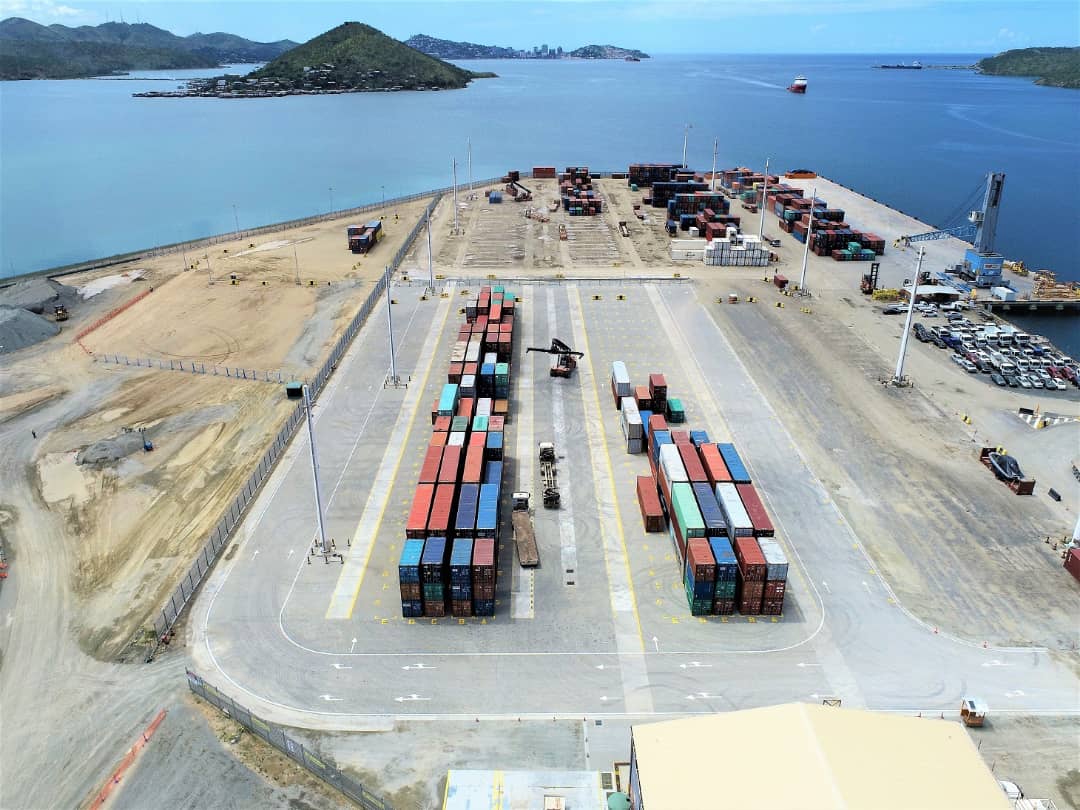 Aerial view of Motukea Port with container stacks, paved traffic lanes and the harbour.