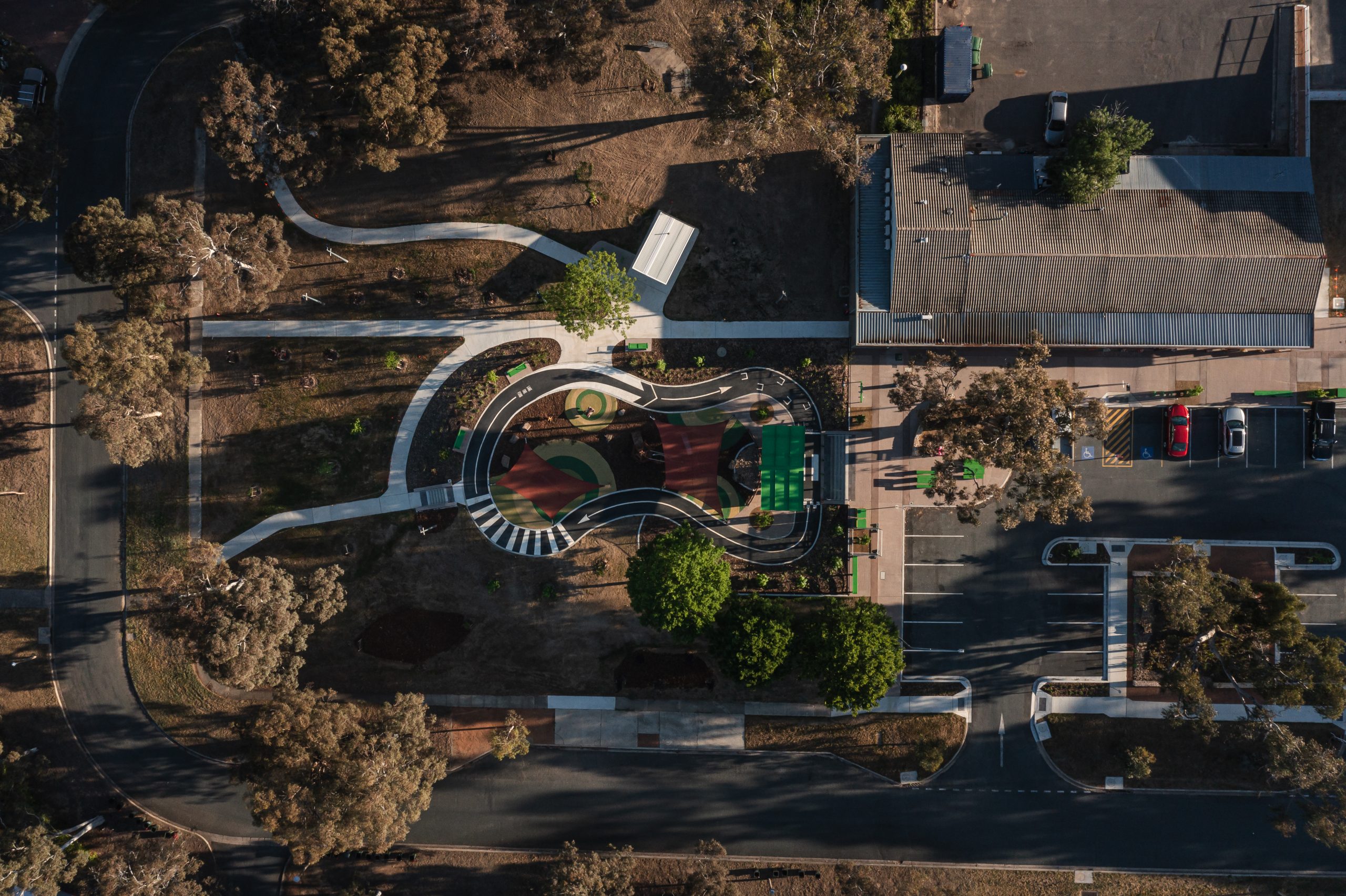 Aerial view of Duffy Shopping Centre, its playground, paths and surrounding landscape.