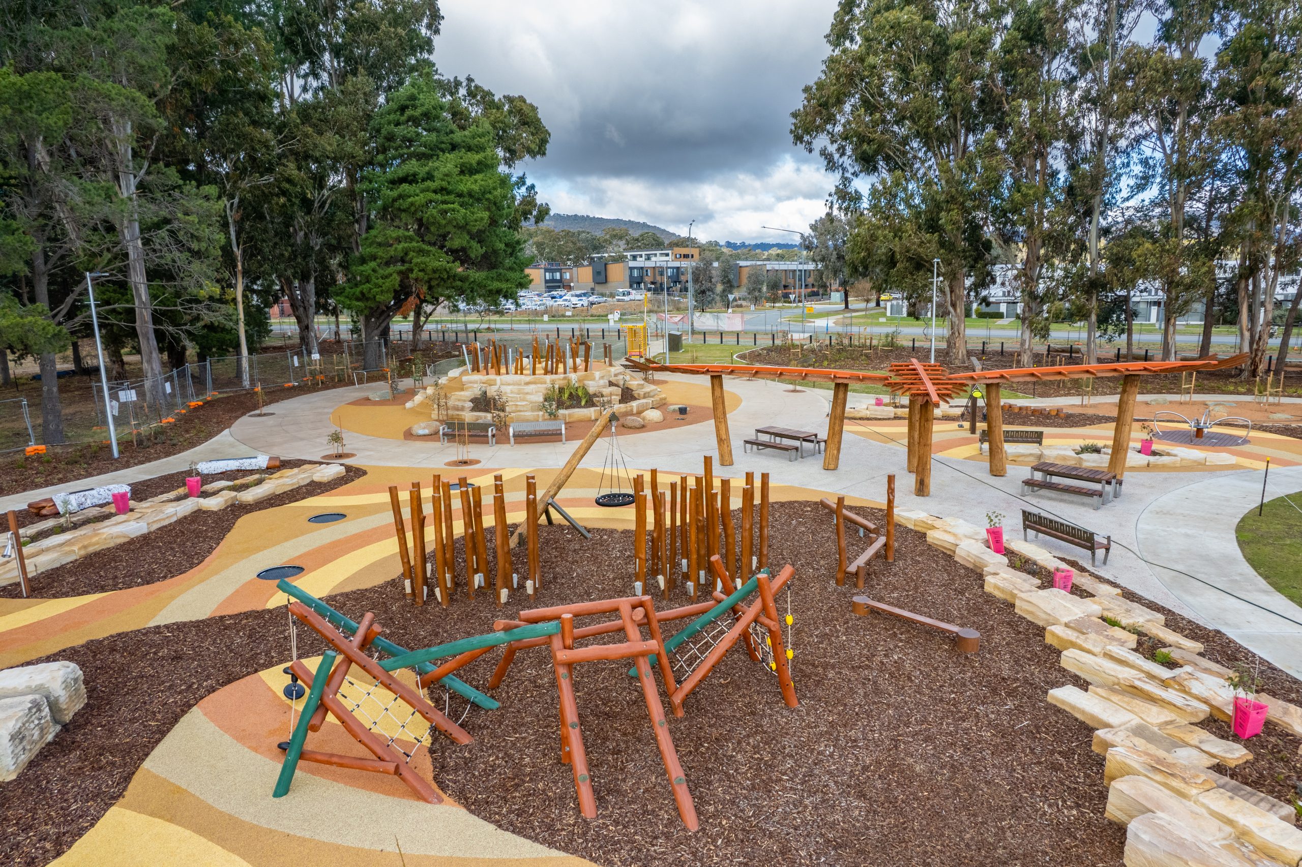 Timber play elements, stone edges and the Maliyan structure, July 2024.
