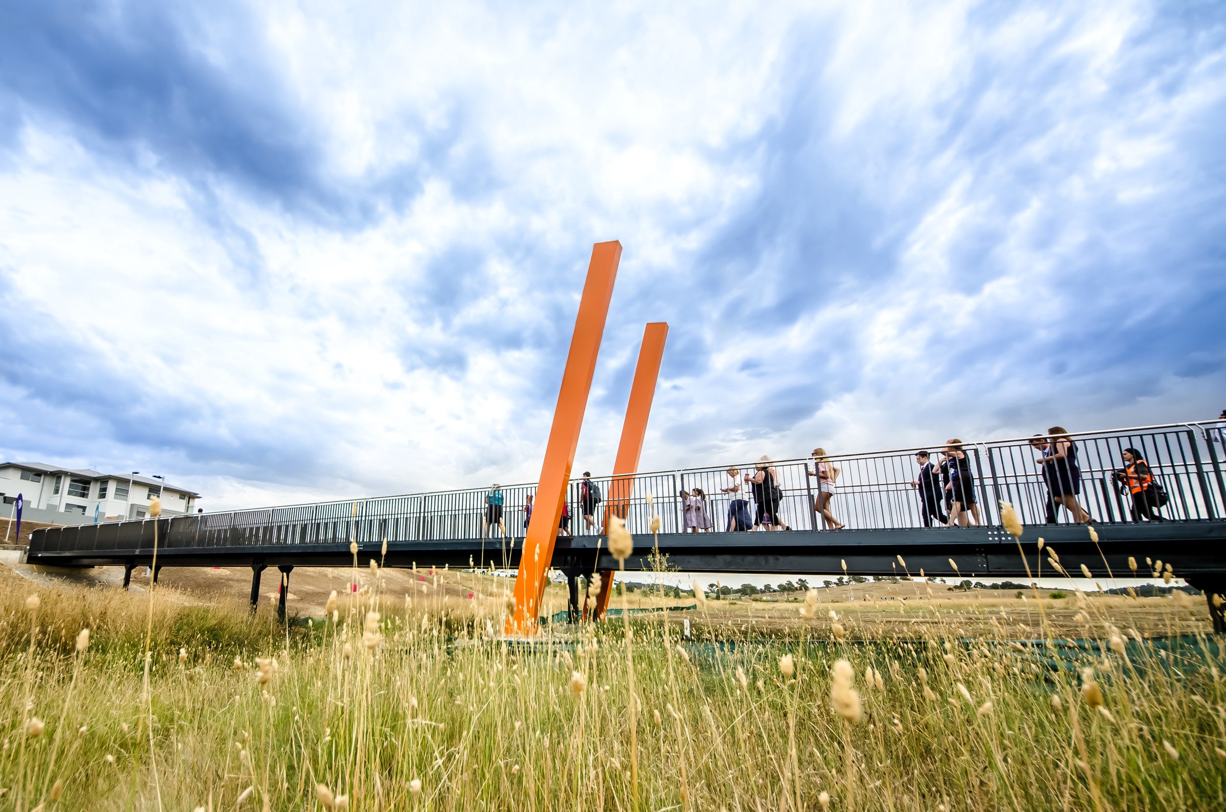 Wagi Bridge with tall orange markers above the creek landscape.